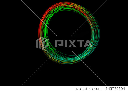 Vibrant freeze light circle displays bright colors in swirling patterns against a dark background, creating a stunning visual effect Vibrant freeze light circle displays bright colors in swirling patterns against a dark background, creating a stunning visual effect 143770504
