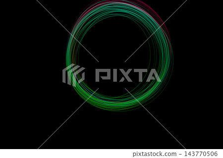 Colorful light circle formed using freeze light technique, showcasing vibrant colors against a dark background at night 143770506