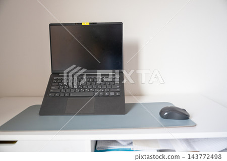 Laptop computer with wireless mouse on minimalist home office desk with copy space Laptop computer with wireless mouse on minimalist home office desk with copy space 143772498