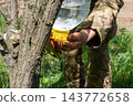 Ukrainian soldier washing hands using an improvised plastic bottle water 143772658