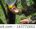Ukrainian soldier washing hands using an improvised plastic bottle water 143772662