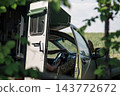 Military vehicle with soldier inside resting in the field 143772672