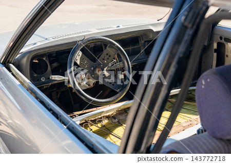 Abandoned classic car dashboard with stripped interior and missing instrument panel during restoration project Abandoned classic car dashboard with stripped interior and missing instrument panel during restoration project 143772718
