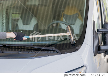 person cleaning motorhome windshield with squeegee during vehicle maintenance and travel preparation 143773128