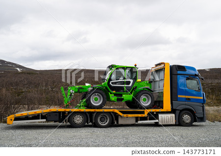 Telehandler loaded on flatbed truck in remote arctic landscape of Finnish Lapland Telehandler loaded on flatbed truck in remote arctic landscape of Finnish Lapland 143773171