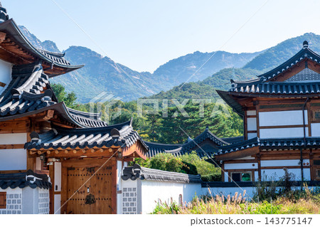 Traditional Korean Hanok Houses and Tiled Roofs against Bukhansan Mountain in Eunpyeong Hanok Village, Seoul Traditional Korean Hanok Houses and Tiled Roofs against Bukhansan Mountain in Eunpyeong Hanok Village, Seoul 143775147