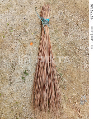 Traditional coconut leaf broom on ground 143775180
