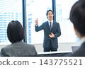 Business people discussing their opinions in a meeting against a backdrop of urban scenery. 143775521