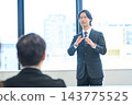 Business people discussing their opinions in a meeting against a backdrop of urban scenery. 143775525