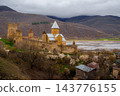 Ananuri Fortress complex with towers, churches and blossoming trees above reservoir in spring, Georgia 143776155
