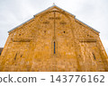 Carved stone cross on golden church gable at Ananuri Fortress, low angle, Georgia 143776162