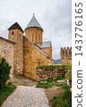 Ananuri church with conical roof, watchtower and cobblestone path in fortress, Georgia 143776165