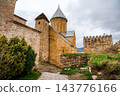 Ananuri church with conical roof, watchtower and cobblestone path in fortress, Georgia 143776166