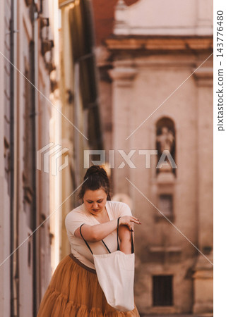 Woman Searching Tote Bag on Historic City Street Woman Searching Tote Bag on Historic City Street 143776480