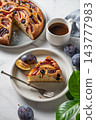 Homemade plum pie for breakfast and a cup of coffee 143777983