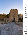 Fortified Gate Tower at Dusk with Alcazar in Background 143778094