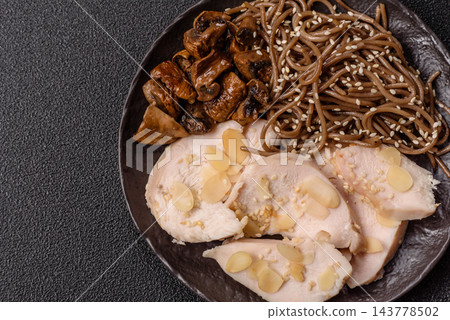 A bowl featuring slices of boiled chicken fillet, buckwheat noodles, and mushrooms A bowl featuring slices of boiled chicken fillet, buckwheat noodles, and mushrooms 143778502