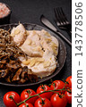 A bowl featuring slices of boiled chicken fillet, buckwheat noodles, and mushrooms 143778506