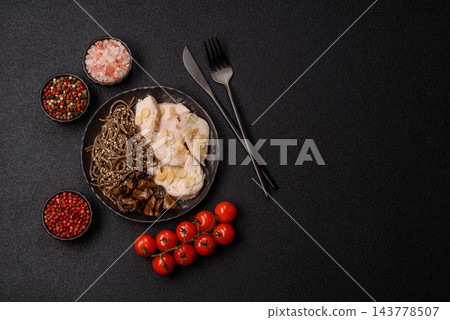 A bowl featuring slices of boiled chicken fillet, buckwheat noodles, and mushrooms 143778507