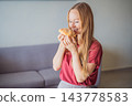 Woman enjoying pan de muerto during a Mexican seasonal food experience. 143778583