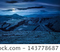 mountainous rural landscape of ukraine on spring night. picturesque highland under dark sky. grassy meadow in full moon light. carpathian countryside scenery with forest on a hill behind the pasture 143778687