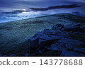 Carpathian mountain summer landscape at night. full moon over meadow with huge stones among the grass on top of the hillside near the peak of mountain range. dark sky. mysterious fantasy 143778688
