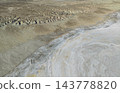 At the foot of an eroded hill bordering the Karinjalik salt flats 143778820