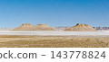 A panoramic view of the Karinjalik hills and the white salt flats. 143778824