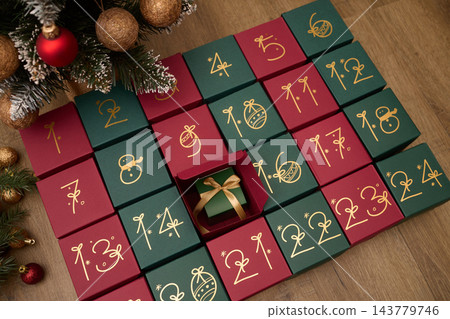 Christmas advent calendar with numbered gift boxes and a hidden holiday surprise Christmas advent calendar with numbered gift boxes and a hidden holiday surprise 143779746