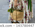 Hand Holding Woven Straw Basket with Fresh Grapes and Leaves in 143780447