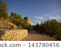 Road leading to the concrete towers of the Amadorio dam surround 143780456