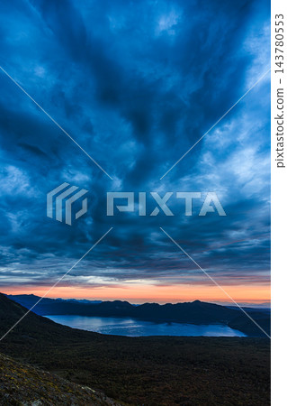 黎明的曙光照亮了天空,周圍的火山口和支笏湖也映入眼簾,景色美不勝收。 黎明的曙光照亮了天空,周圍的火山口和支笏湖也映入眼簾,景色美不勝收。 143780553