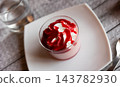 Sweet dessert strawberry mousse whipped to delicate foam is served in small bowl for breakfast. 143782930
