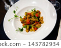 Caponata, chopped fried aubergine with tomatoes and zucchini 143782934