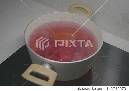 beetroot boiling in a pot of water on a stove. beetroot boiling in a pot of water on a stove. 143786073