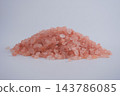 Pink salt crystals piled on a surface in a studio setting 143786085