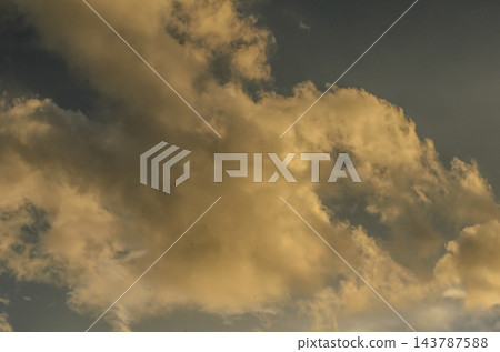 Dramatic scenic photography of golden sunset clouds against a dark evening sky 143787588