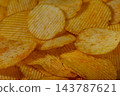 Stock photo of savory crinkle-cut potato chips texture 143787621