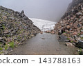 A pond of snow and meltwater remaining between the volcanic rocks of Mount Chokai. 143788163