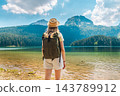 Hiker at Black Lake with Durmitor Mountains in Montenegro 143789912