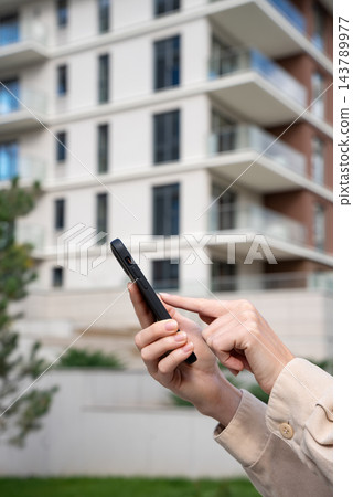 Tenant Searching Apartment Rentals On Smartphone Outside Residential Building. Buyer Browsing Property Listings In Real Estate App. Copy Space. Tenant Searching Apartment Rentals On Smartphone Outside Residential Building. Buyer Browsing Property Listings In Real Estate App. Copy Space. 143789977
