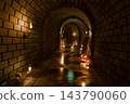 Halloween brick tunnel with glowing jack o lantern pumpkins, burning torches, candles, skulls and skeleton, 3D illustration of a spooky underground dungeon 143790060