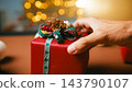 Hand Touching Christmas Gift With Pinecone Decor 143790107
