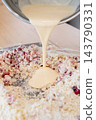Cookies preparation. Dough crumble. Liquid batter pouring from bowl in flour biscuit crust cranberry pile. Treat making background. 143790331