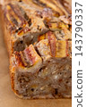 Homemade cake. Sweet loaf. Baked aromatic banana bread garnished with caramelized fruit walnut served by slices on parchment paper. 143790337