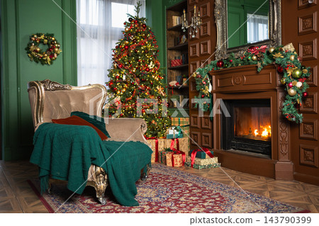 Classical Christmas decorated interior living room with fireplace. Christmas tree with red golden ornament decorations gift boxes. Modern classic style interior design apartment. Christmas eve at home Classical Christmas decorated interior living room with fireplace. Christmas tree with red golden ornament decorations gift boxes. Modern classic style interior design apartment. Christmas eve at home 143790399