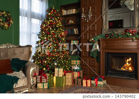 Classical Christmas decorated interior living room with fireplace. Christmas tree with red golden ornament decorations gift boxes. Modern classic style interior design apartment. Christmas eve at home 143790402