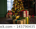 Many gift boxes in classical Christmas decorated interior living room library with fireplace. Christmas gift near fir tree. Modern classic style interior design apartment. Christmas eve at home 143790435