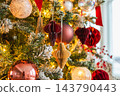 Merry Christmas Xmas happy holidays. Golden ornament decoration ball and defocused garland lights on classic decorated Christmas tree. Christmas tree with red white ornaments. Christmas eve at home 143790443