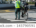 The back view of a parking enforcement officer crossing an intersection 143790591